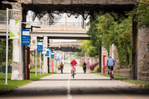 People biking and walking on the Dequindre Cut in Detroit.