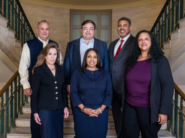 UMCI Staff. Front row, left to right: Lucy Snyder, Gwen Brown, Lauren Atkins Budde. Back row, left to right: Michael Bernal, Scott Shireman, Lutalo Sanifu.