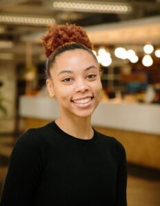 Headshot of UM Detroit Center Associate Project Manager, Mia Nimmons smiling towards the camera.
