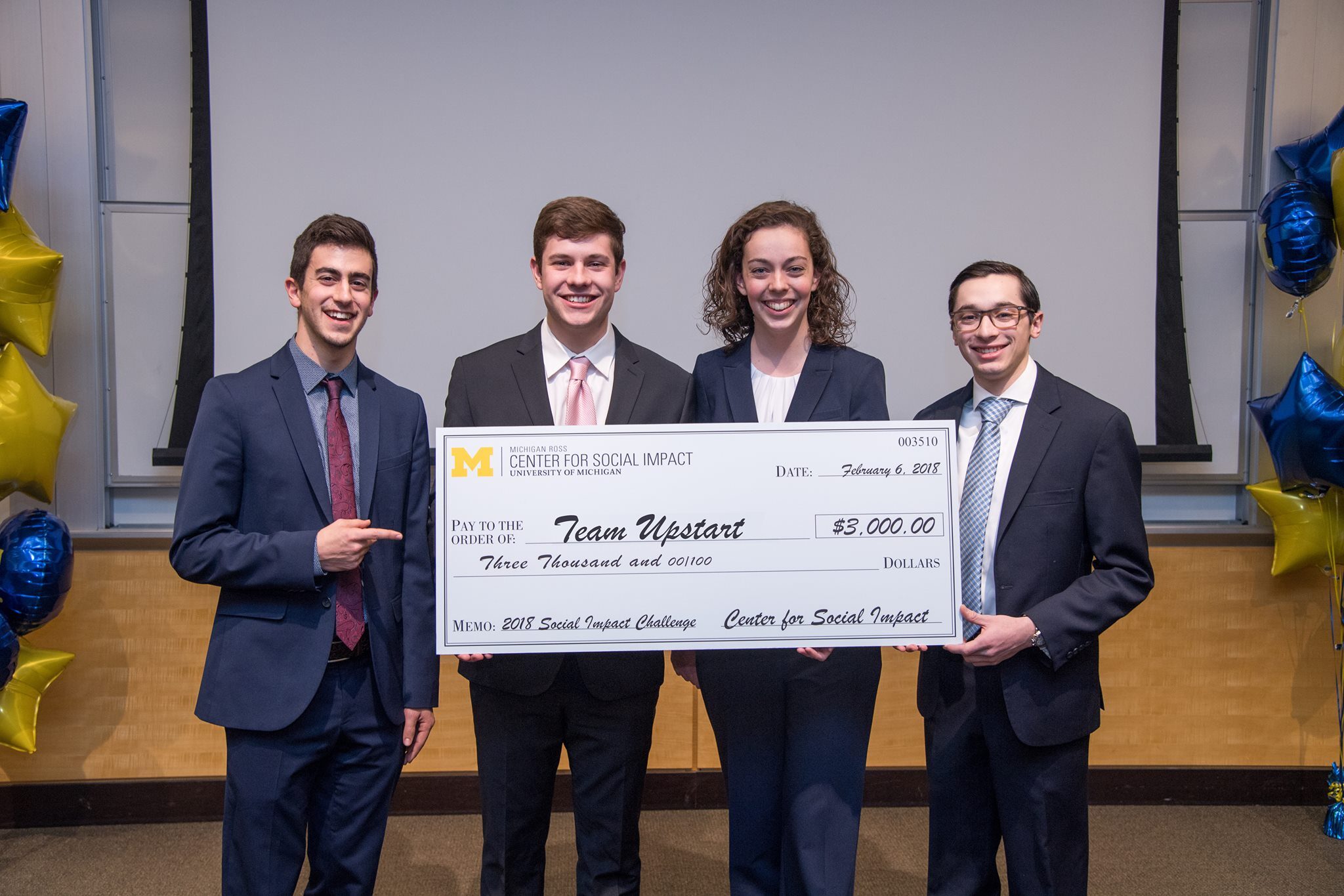 Team Upstart poses with a check for $3,000 that they won in the 2018 Social Impact Challenge